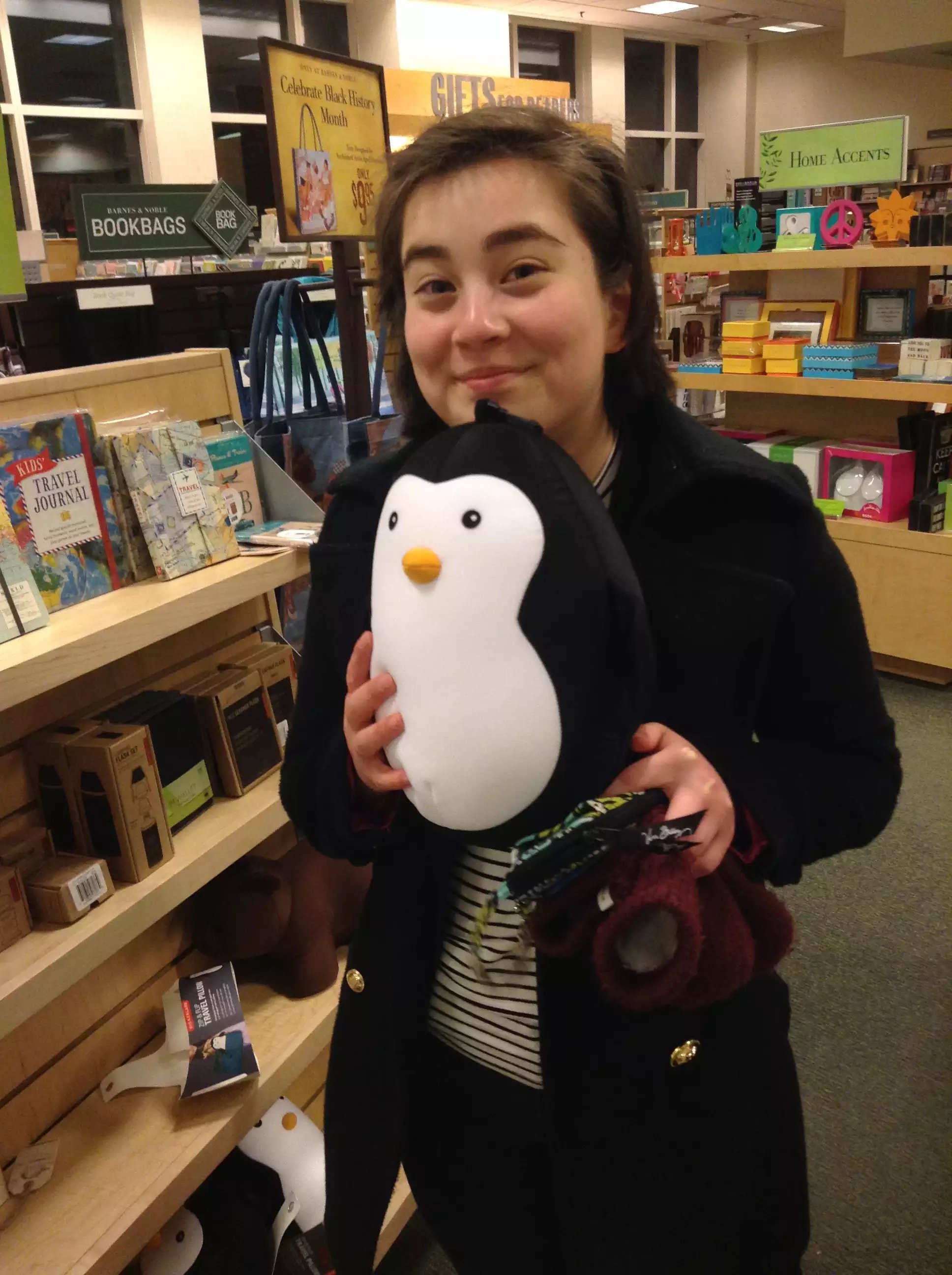 Mei holds a stuffed Juilliard penguin