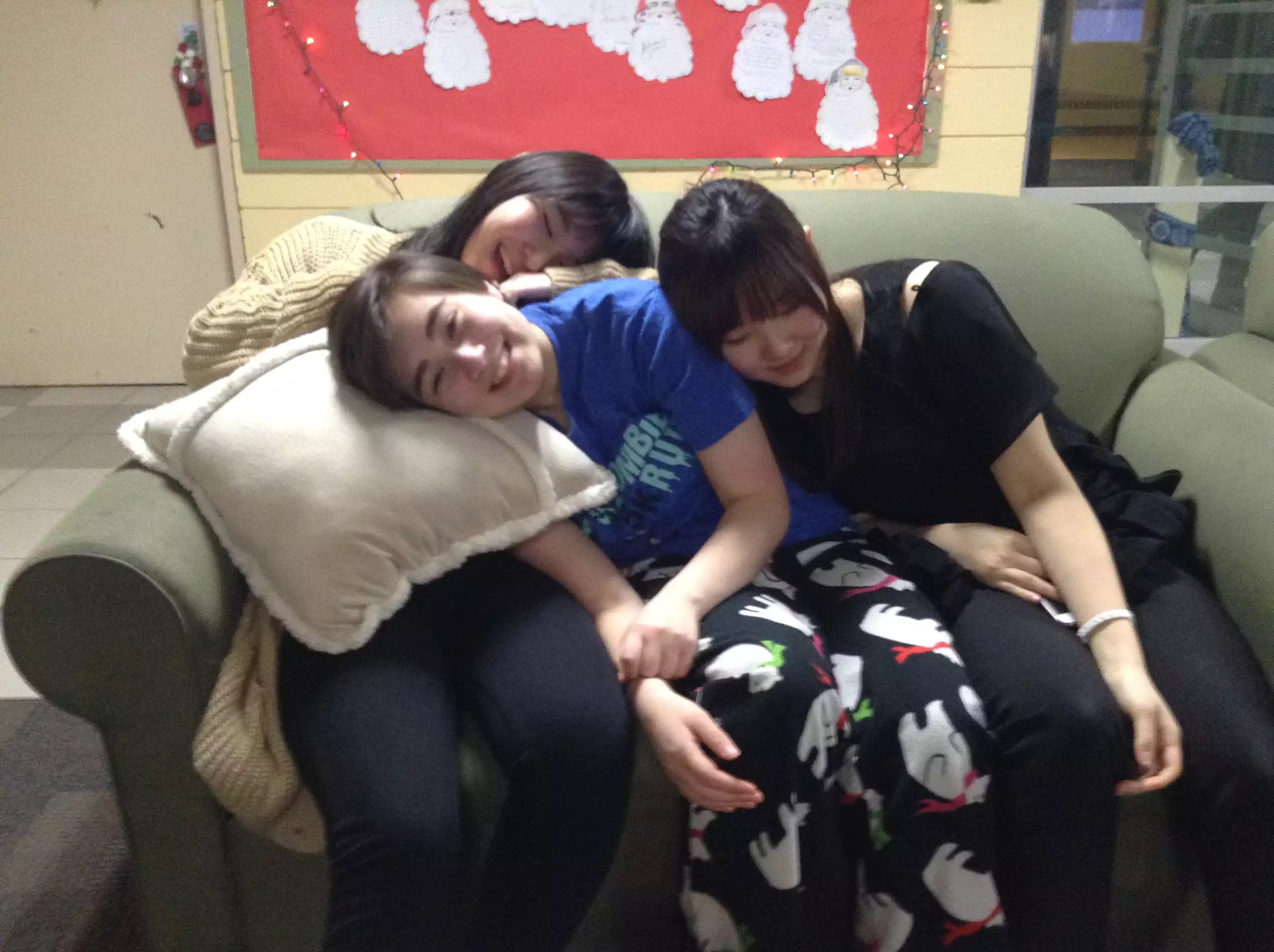 Mei and friends in pajamas on a couch