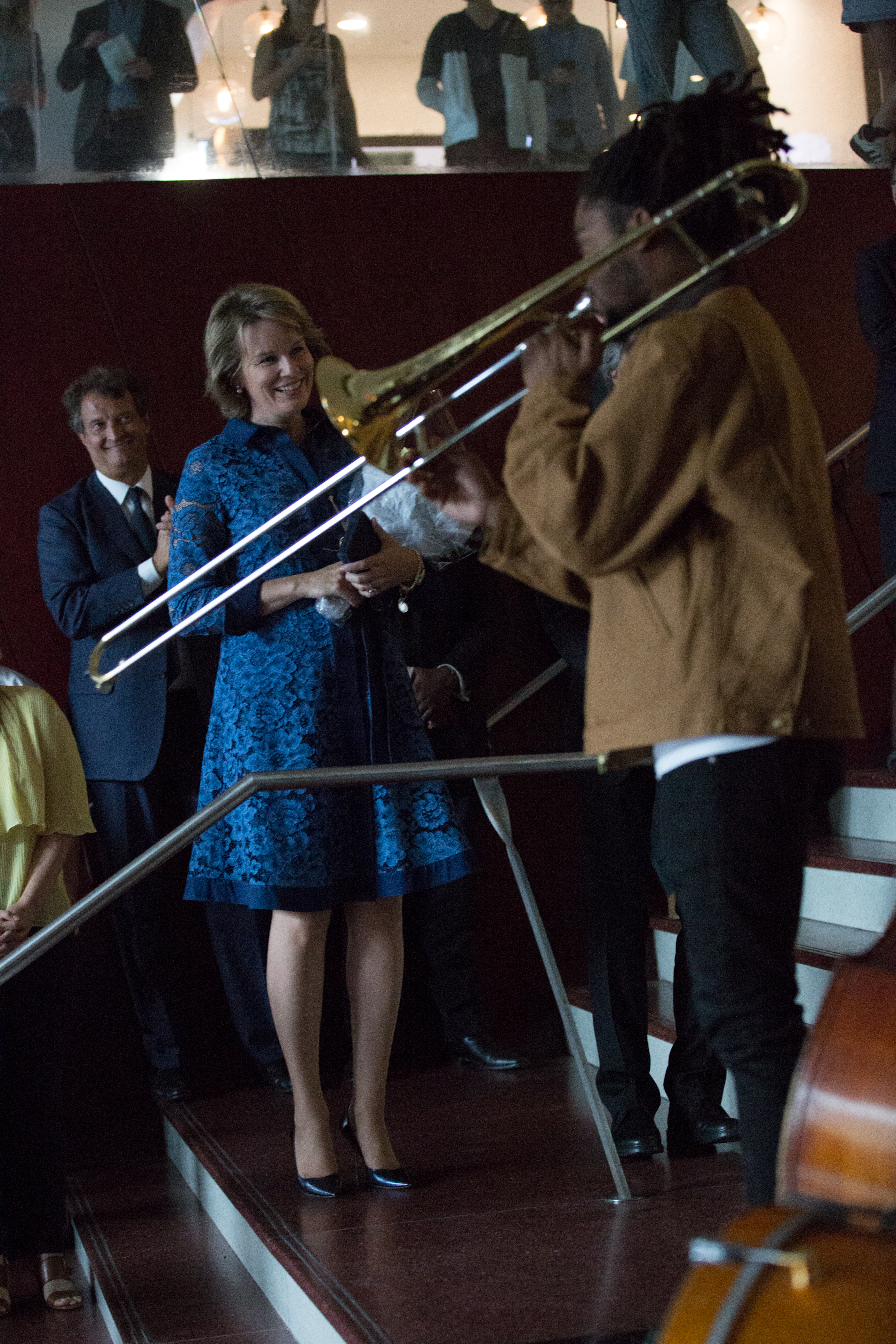 Her Majesty the Queen of the Belgians with an unidentified trombone player on the steps to the Juilliard lobby