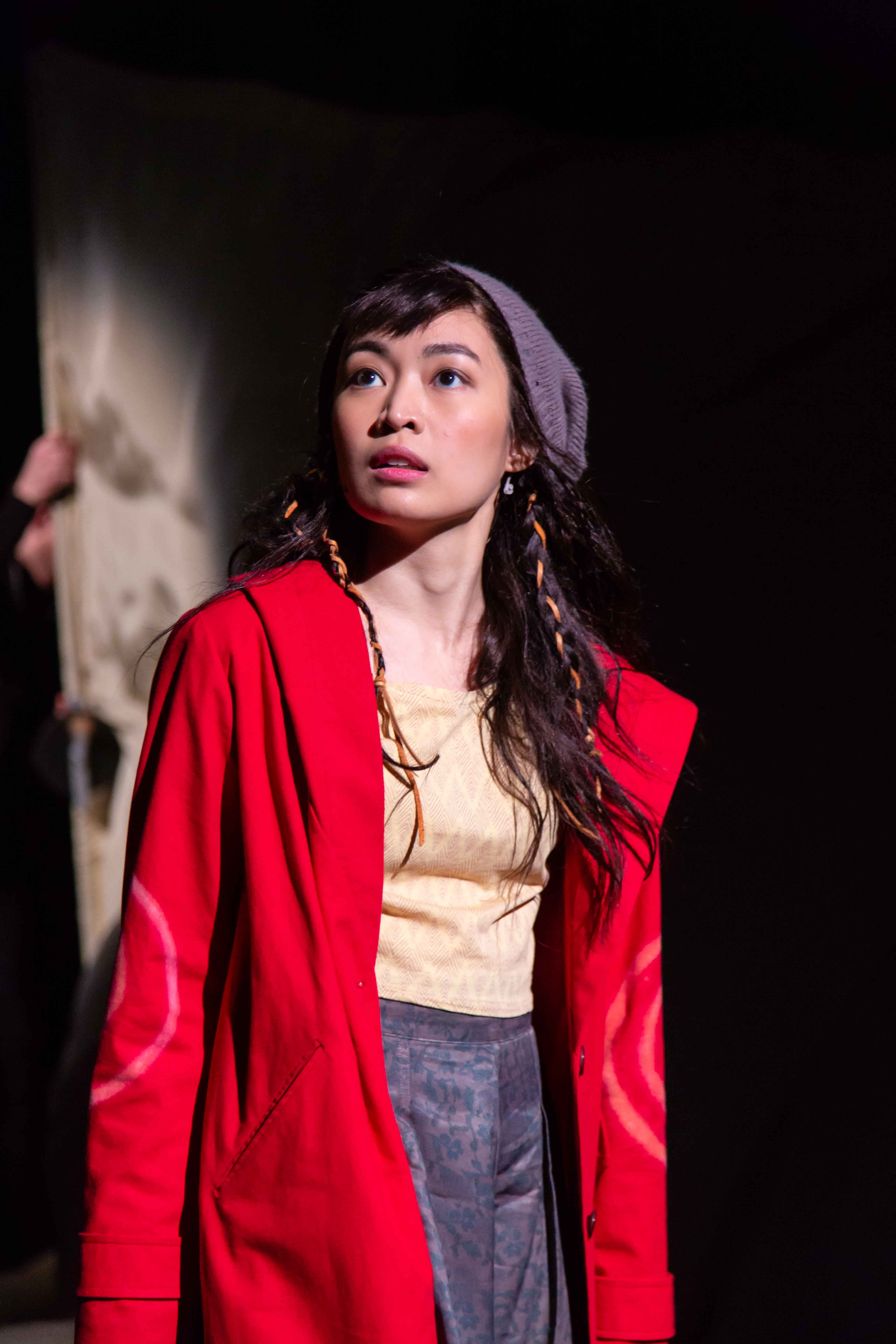 Regina De Vera in a red costume, during performance as Little Red in 'Into the Woods'