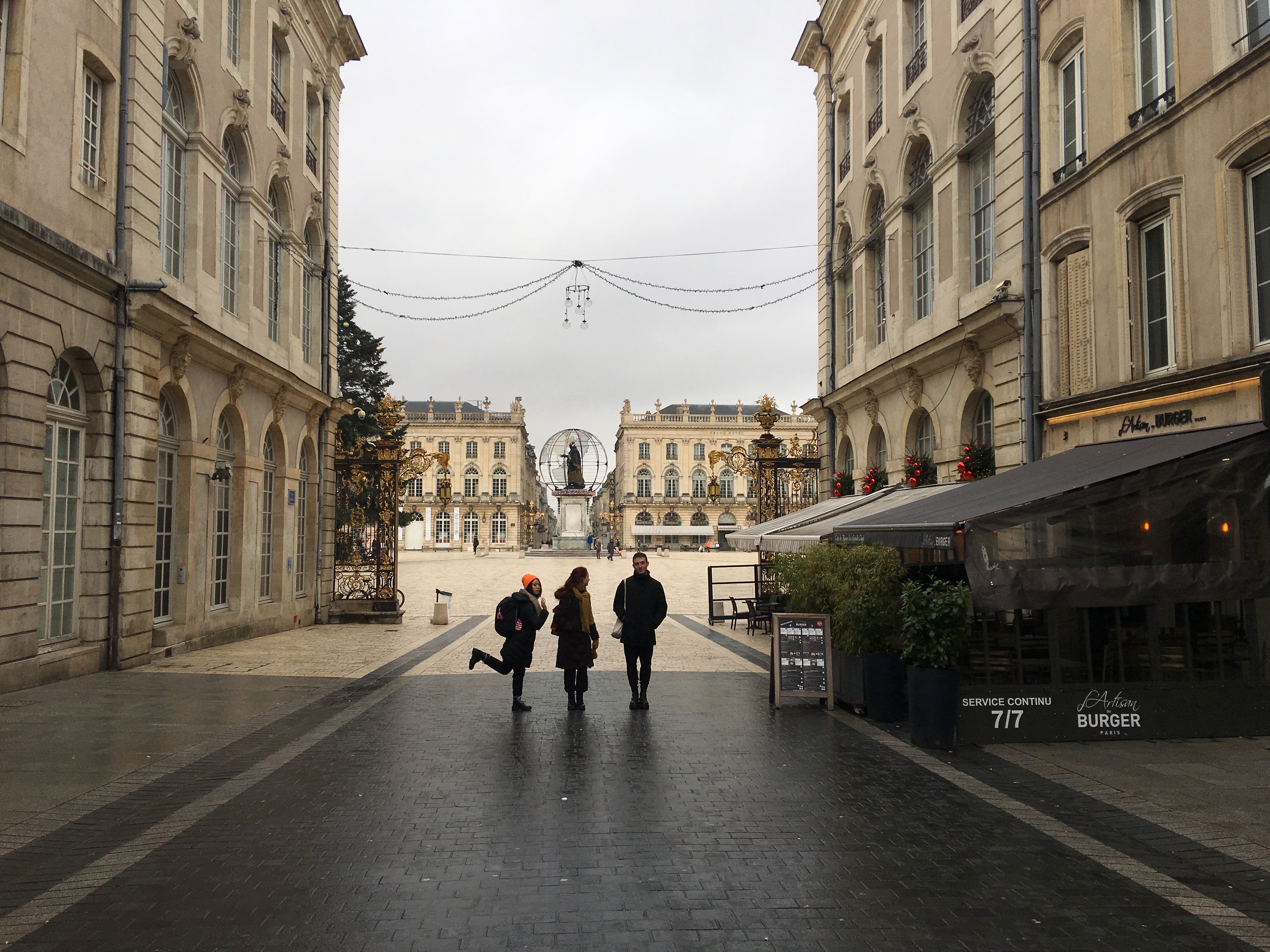 Three friends stand in the street