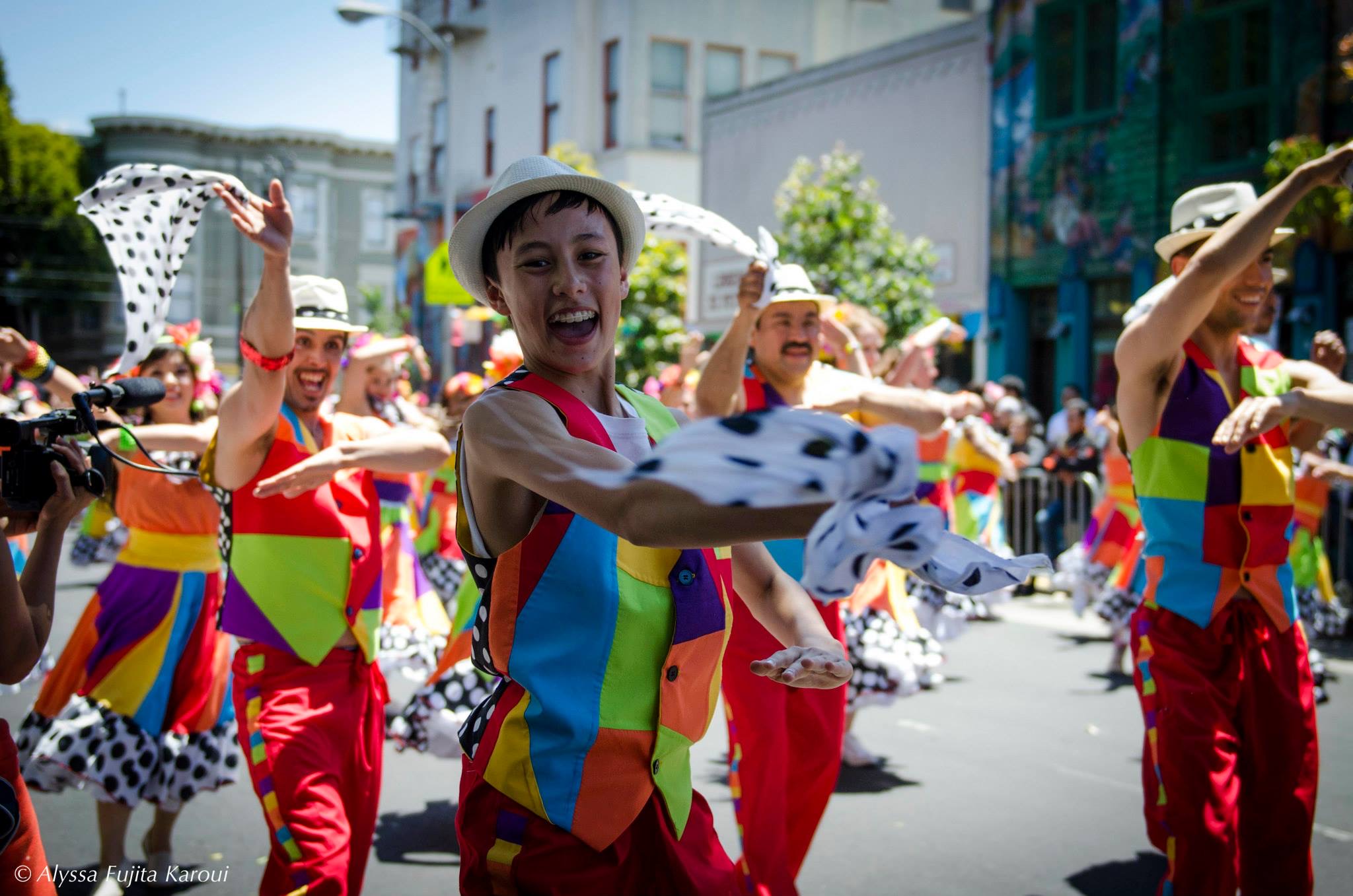 Noah dressed in bright colors in a parade