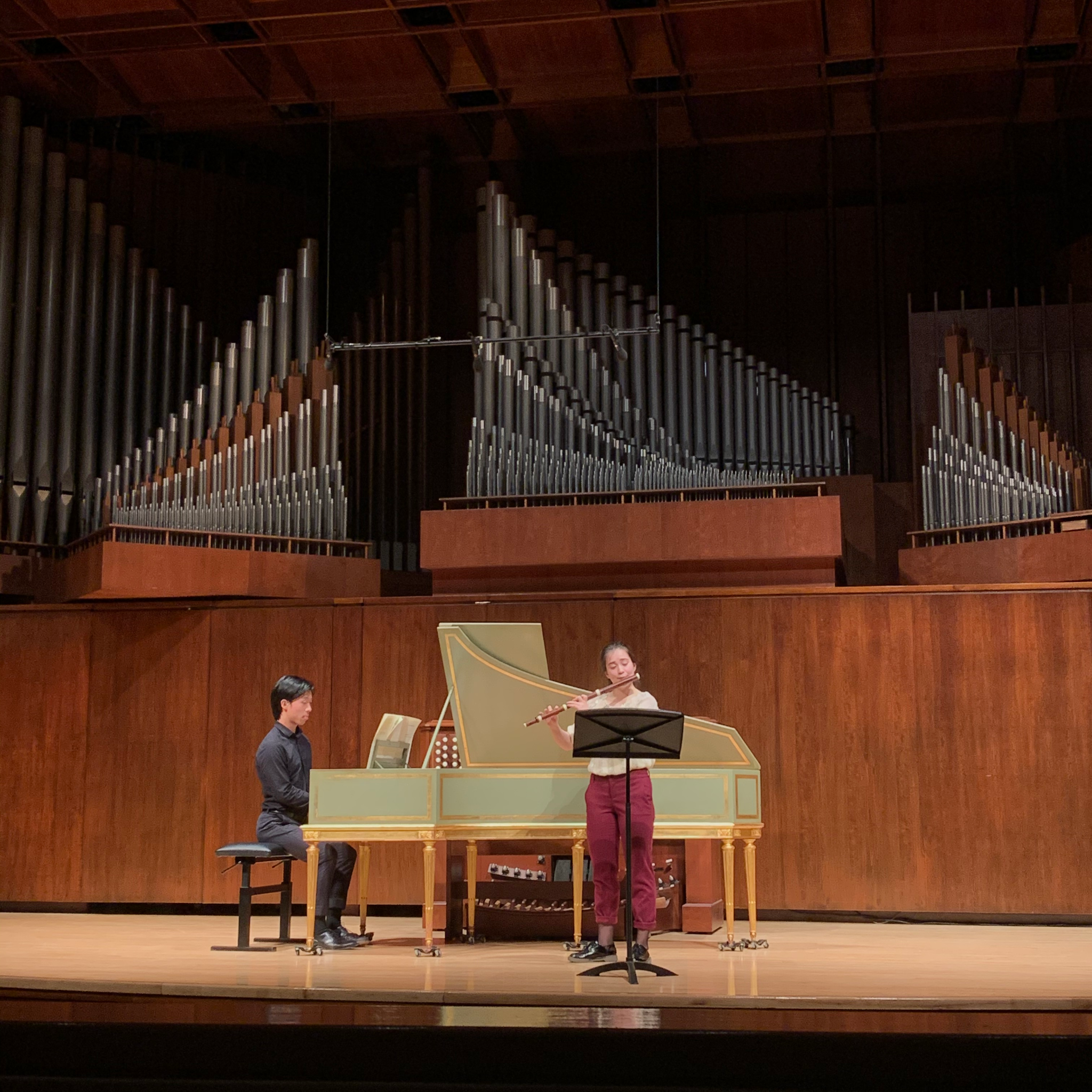 Mei plays flute with a harpsichordist