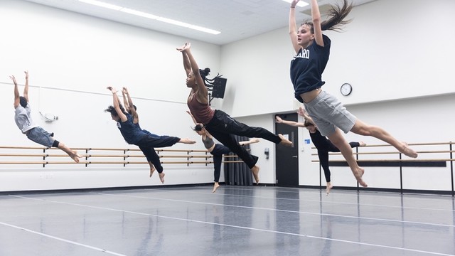 dancers leaping during rehearsal