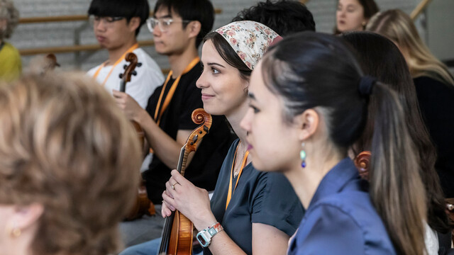 string players smiling in rehearsal