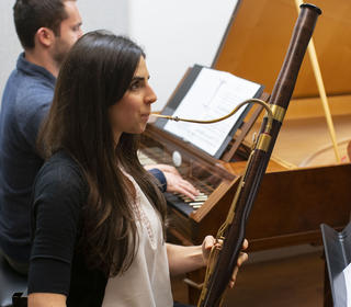 Georgeanne Banker, a first-year bassoonist, is playing the bassoon in a coaching, accompanied by a harpsichordist