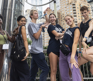 Students assembled in Columbus Circle posing playfully
