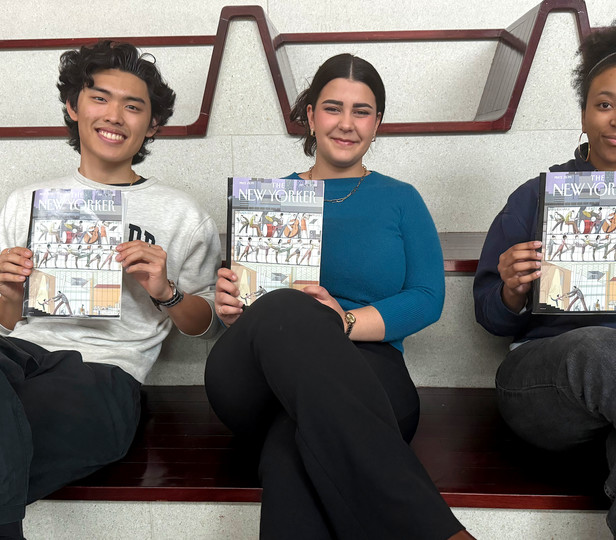 Three students sitting on the large steps at Juilliard's front entrance each hold a copy of 'The New Yorker' magazine. The magazine cover features an illustration of a dance studio with large windows, showcasing people engaged in music and dance. The students smile and they all seem proud to be displaying the magazine.