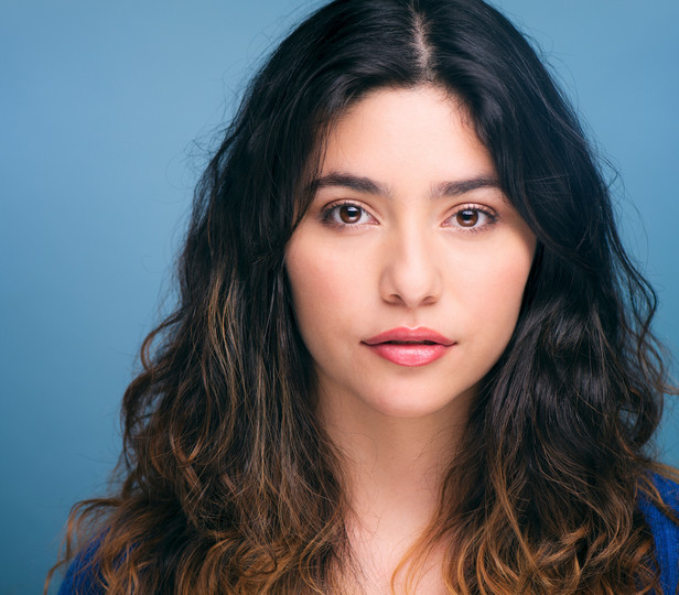 Headshot of Gabriela Torres against a blue background