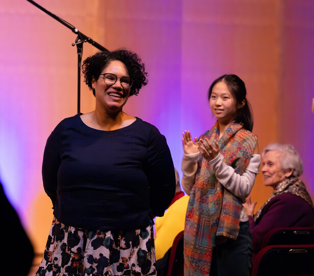 person standing for applause in a group