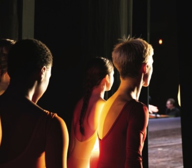 dancers wait for their cue to walk out on stage