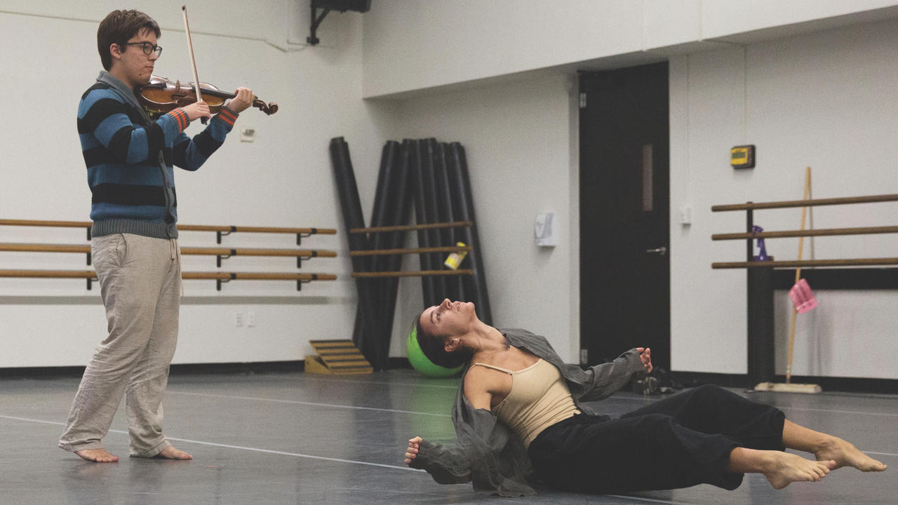 Violinist and dancer in rehearsal
