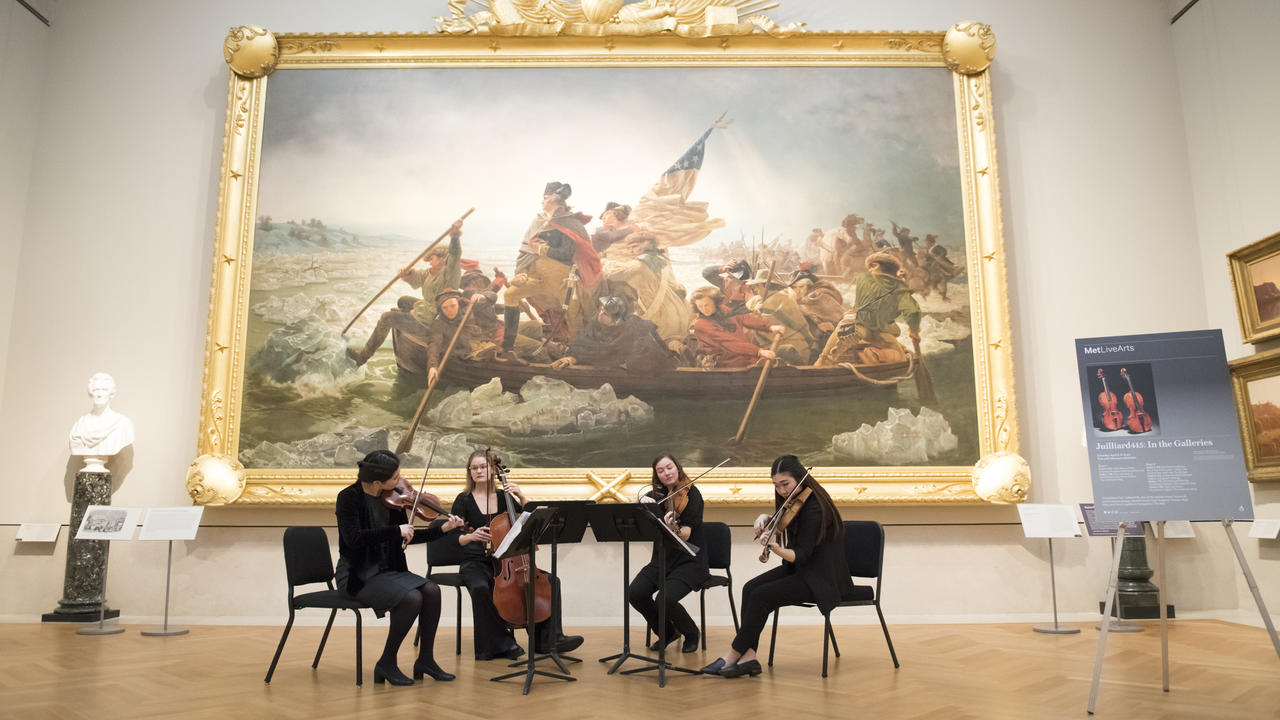 Historical Performance ensemble plays in front of the painting of Washington crossing the Delaware at the Metropolitan Museum of Art in New York City