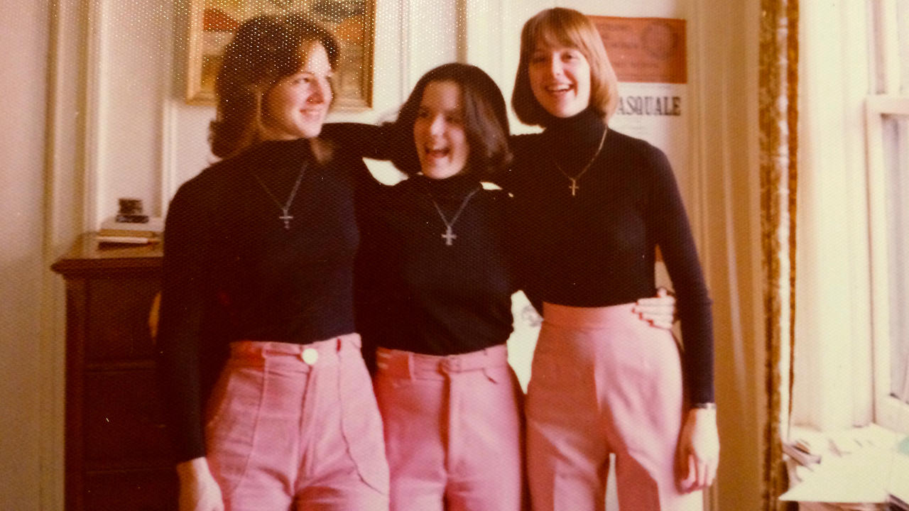 Sharon Smith Prolifrone, Susan Branscom Taylor, and Barli Nugent wearing coordinated black and pink outfits with cross necklaces 