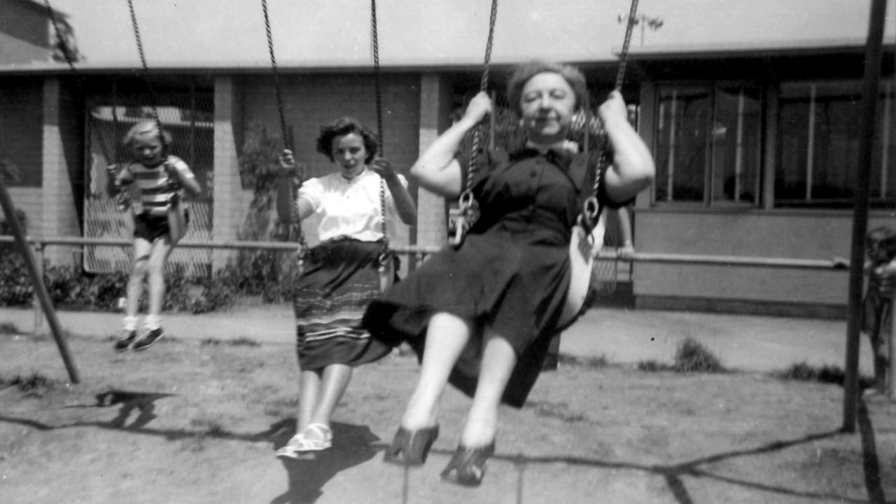 Irene Maria Schneidmann and Rosina Lhévinne in a black and white photo on a swing set in 1952