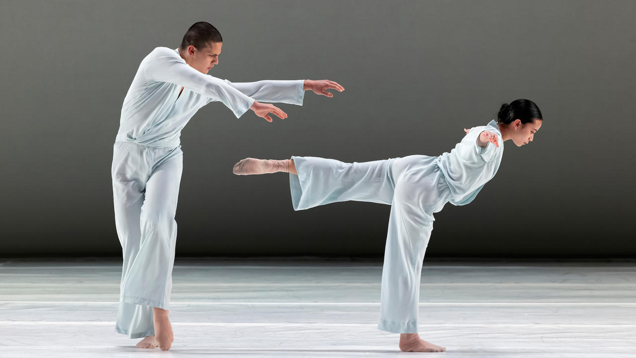 Two dancers are on stage during a performance