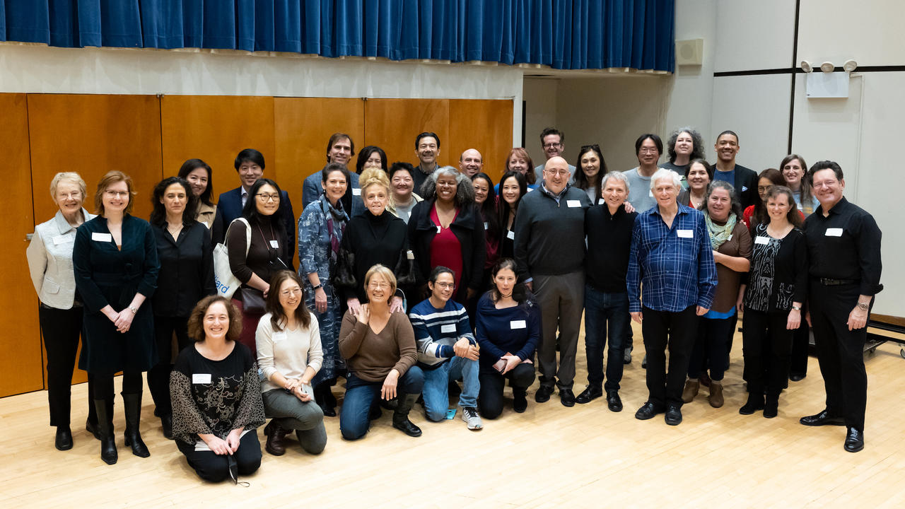 A group photo from the reunion taken in an orchestral studio