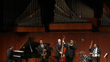 A group of jazz musicians plays in Paul Hall at Juilliard