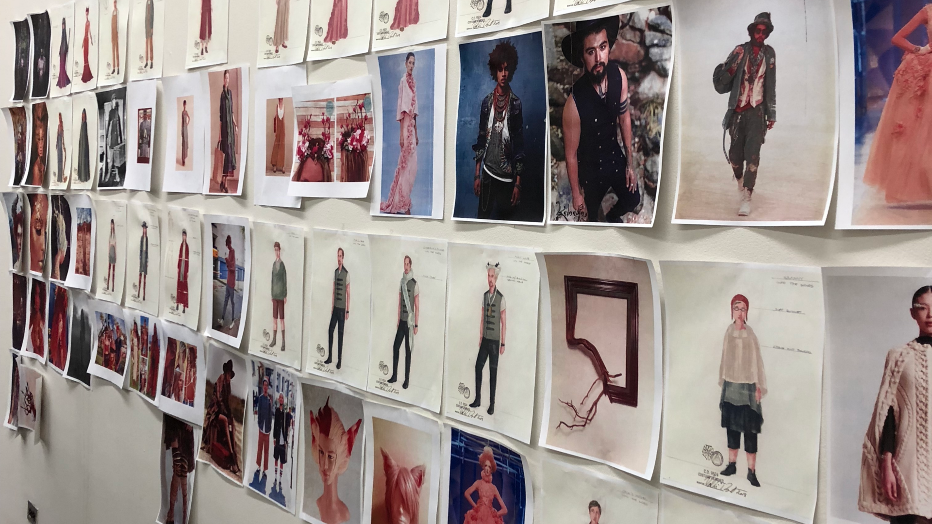 costume concepts posted on a wall