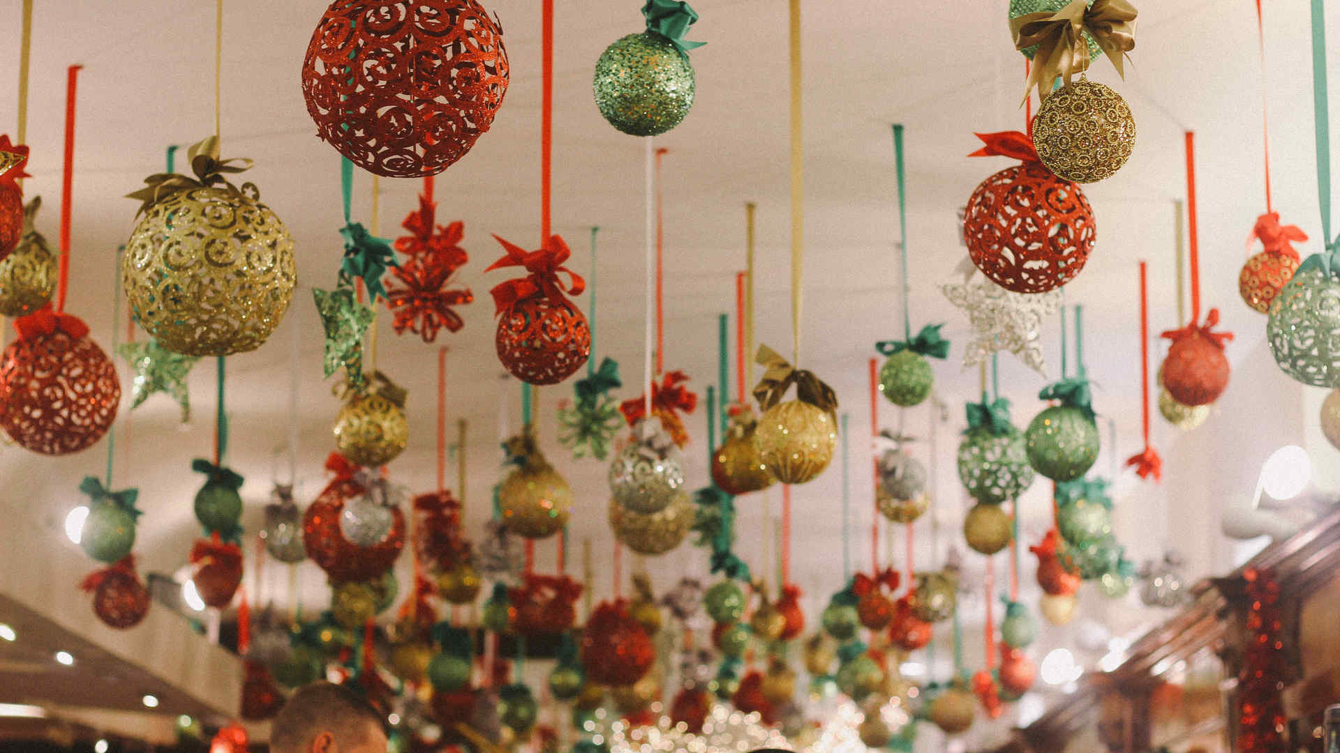 Holiday ornaments hanging from a ceiling