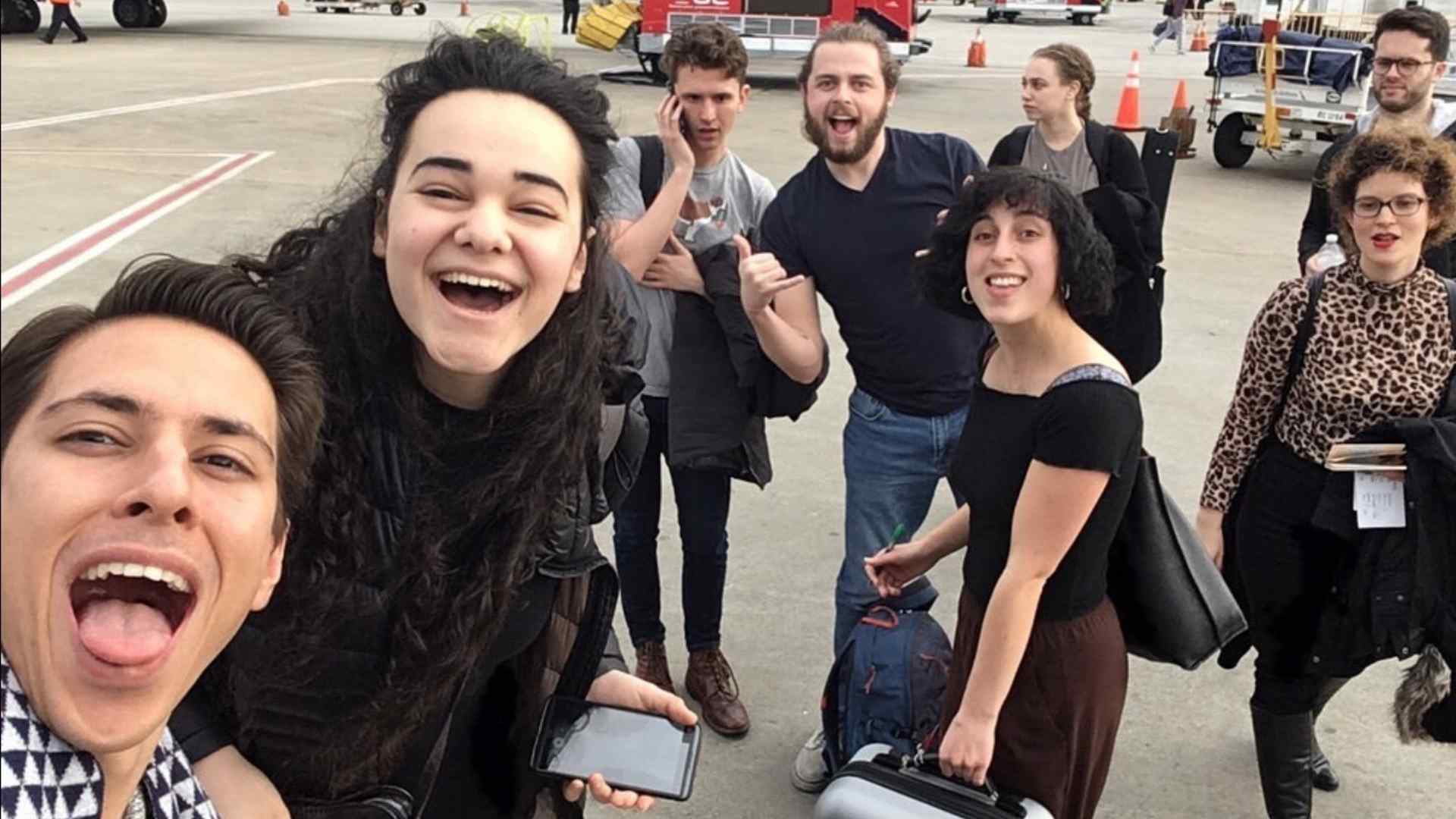 A group selfie of the Dido and Aeneas cast at an airport