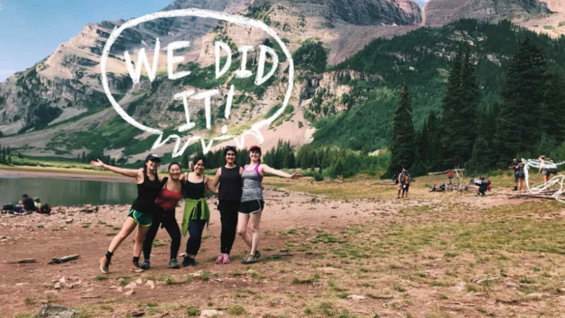 Mei and friends in front of a mountain. A speech bubble reads 'We did it!"