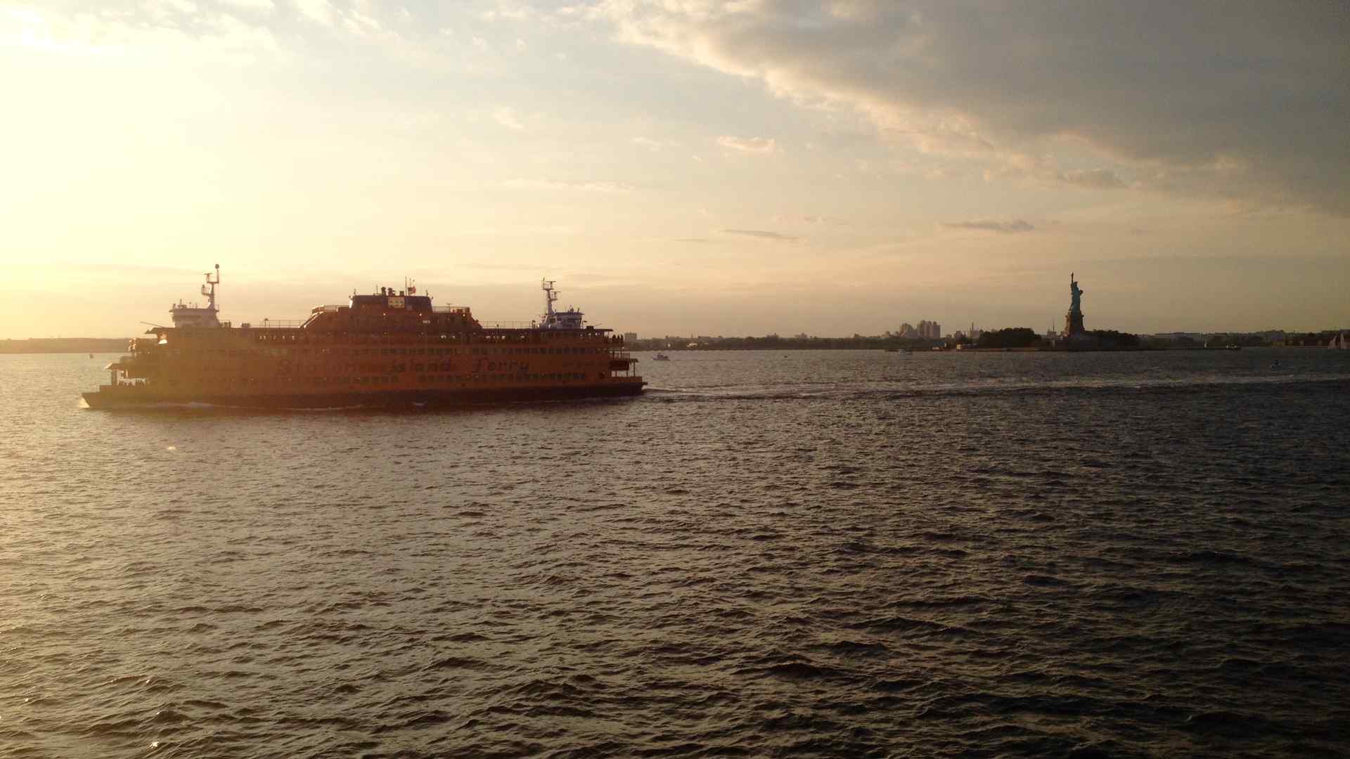 The Staten Island Ferry passes the Statue of Liberty