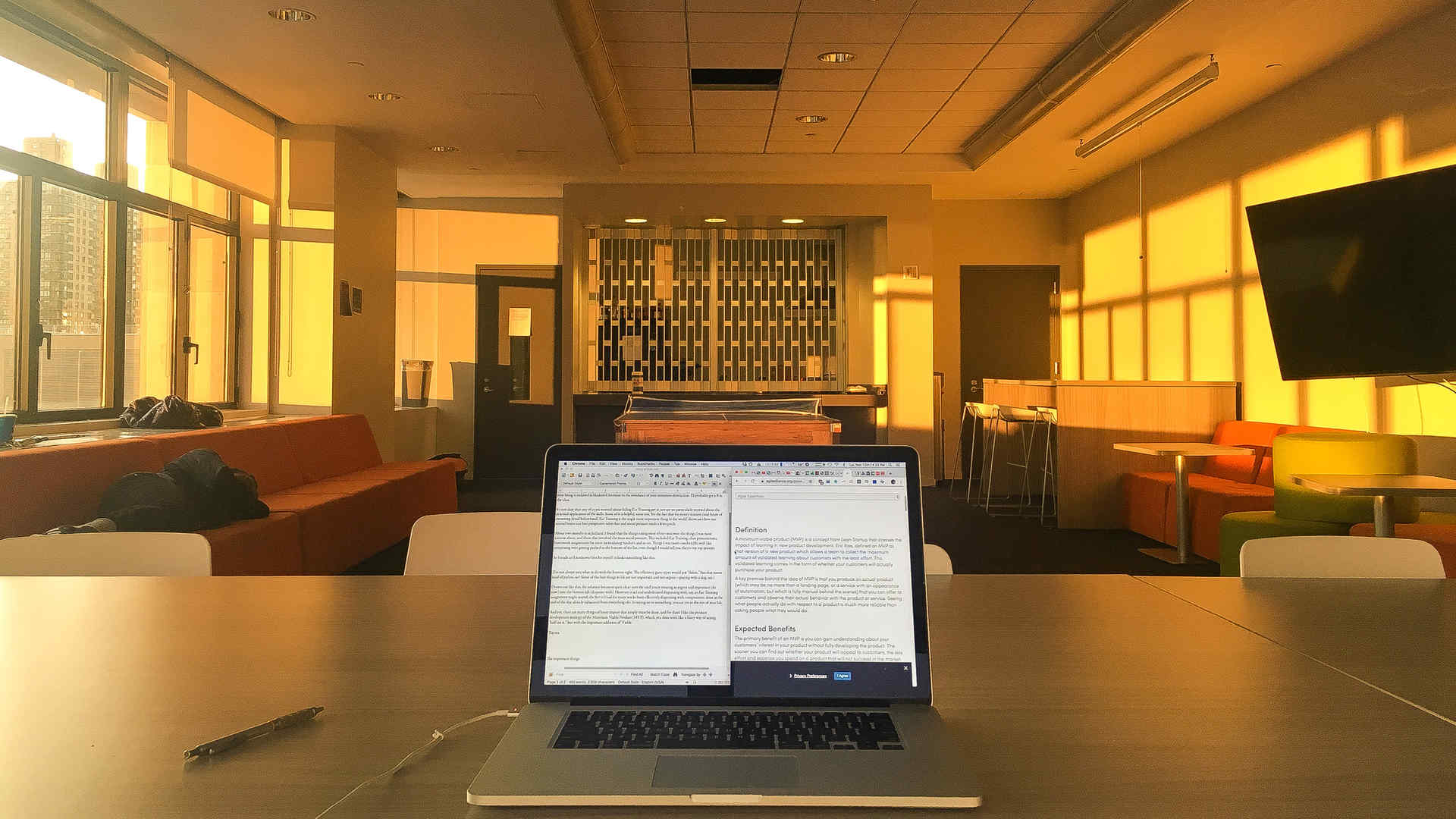 A laptop on a table in the library