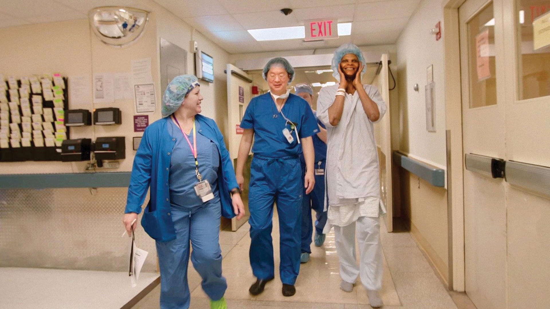 A still from the documentary 'Born to Be' showing Jess Ting, flanked by an unidentified patient and an unidentified medical staff member