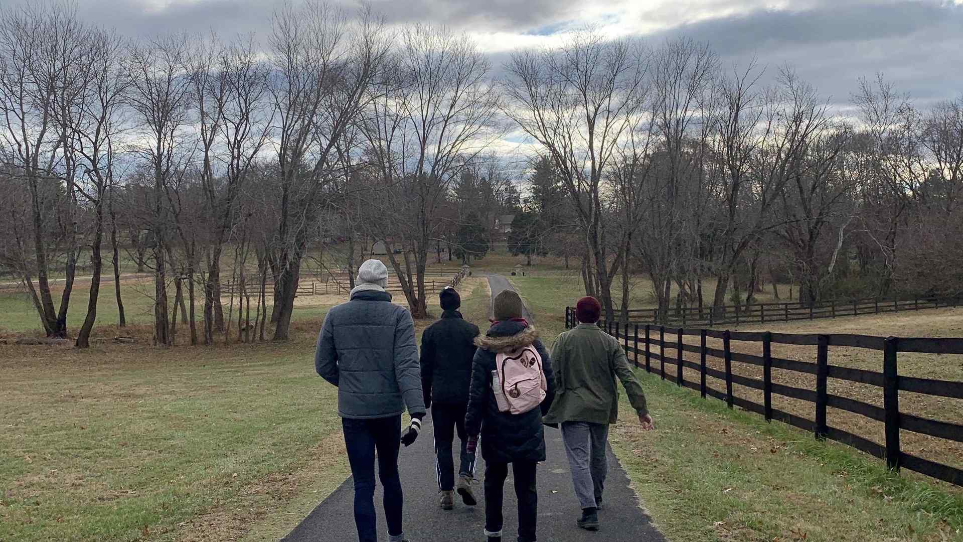 A group of students walk through a field