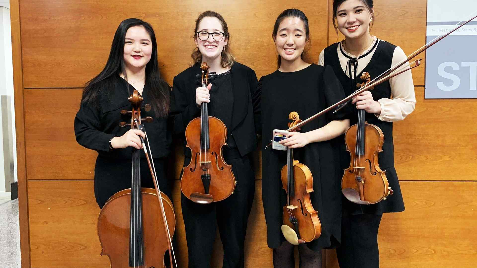 Amy poses with three other string players