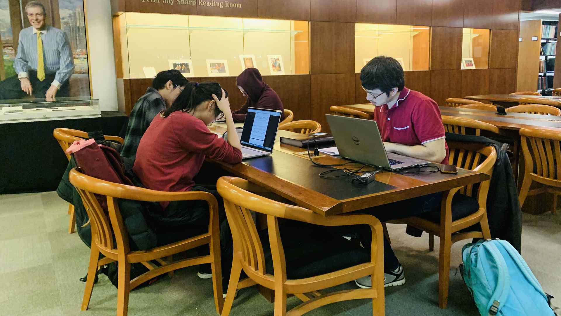 Composition students sit at a table in the Juilliard library
