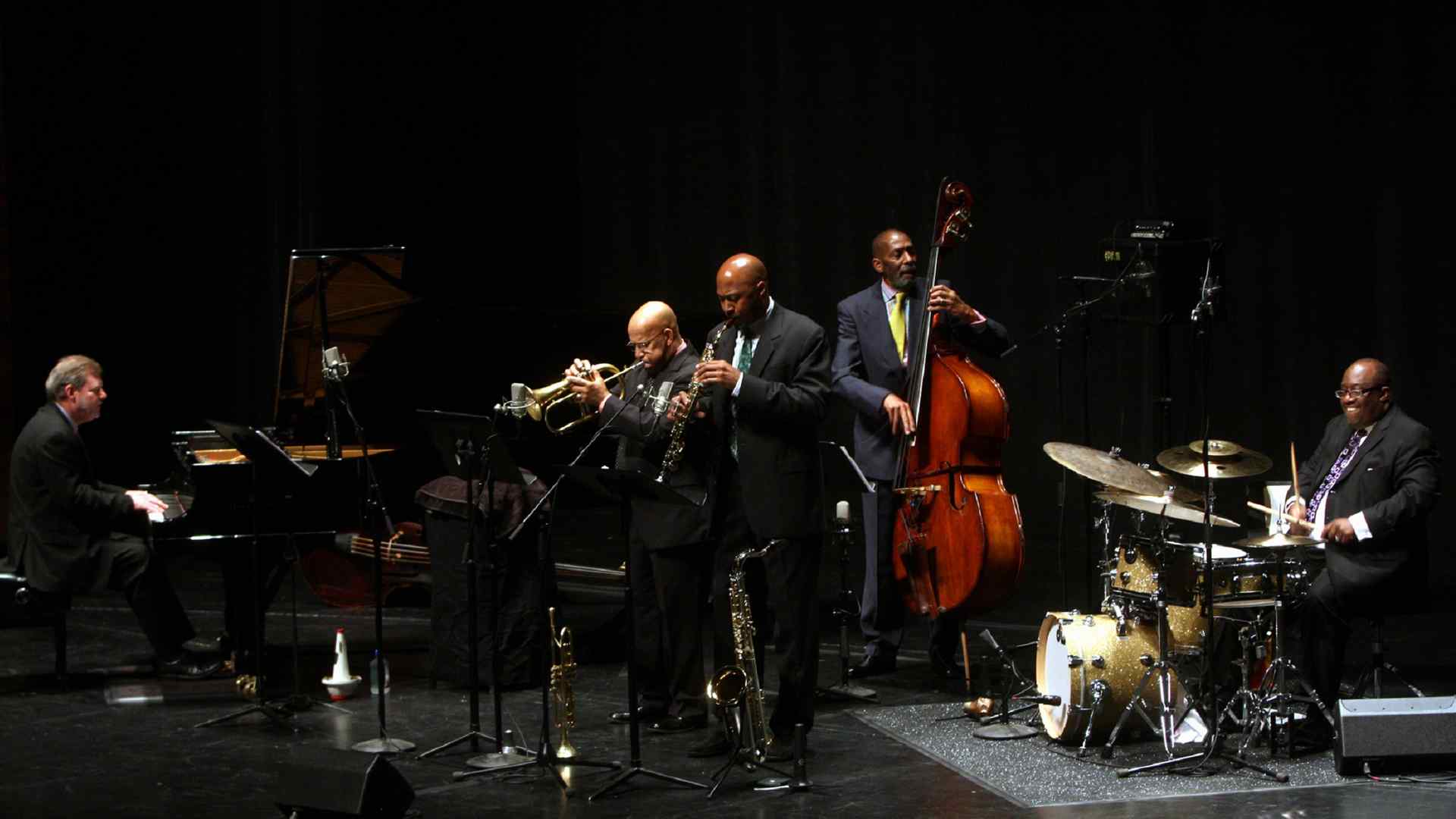 An ensemble of jazz musicians, including Frank Kimbrough at the keyboard, performing