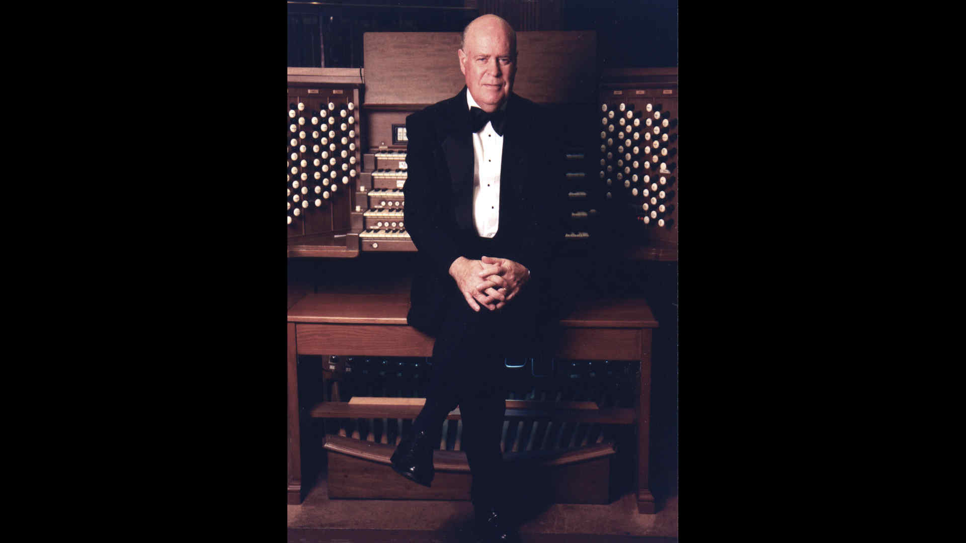 John Weaver sitting at the organ