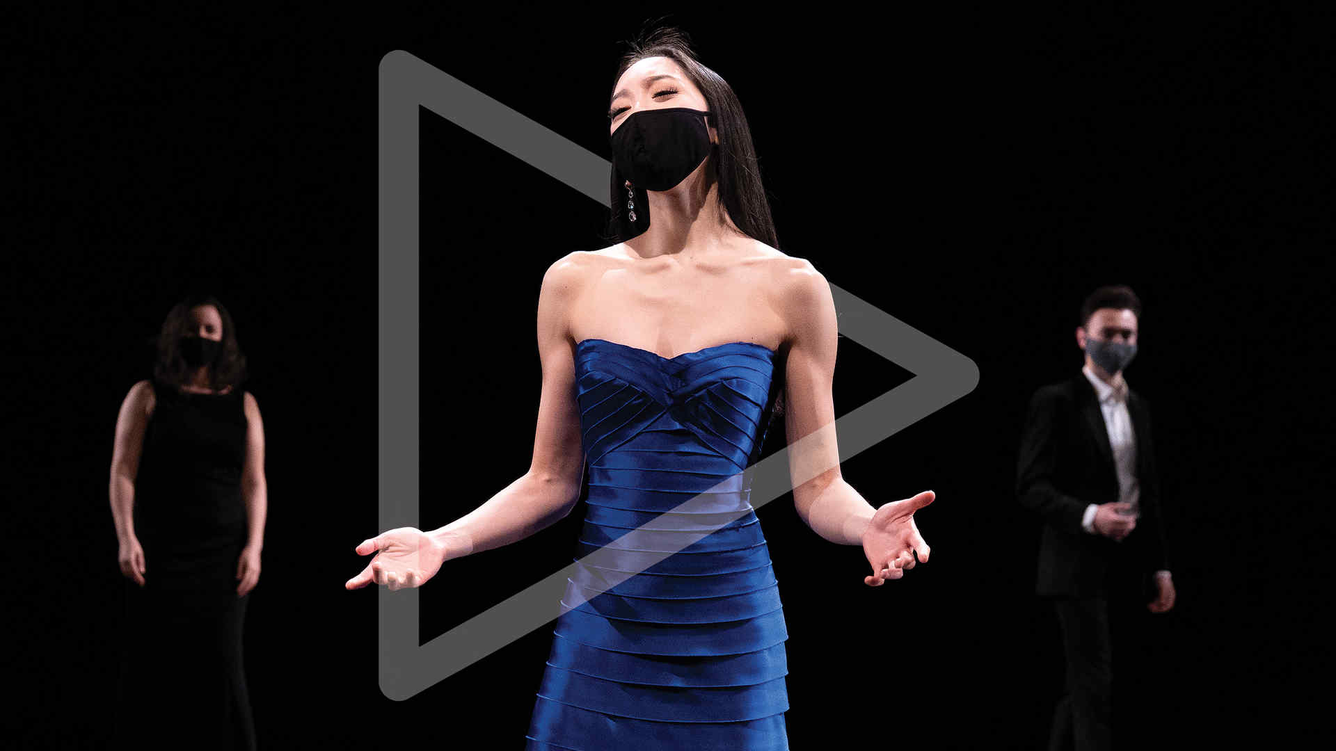 Three performers on stage and a grey play button is superimposed on the middle performer to communicate on-demand playability of the Juilliard LIVE offerings