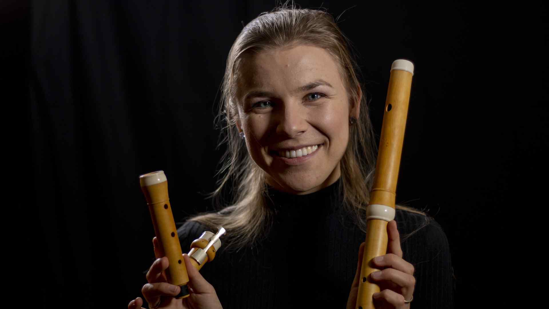 Taya König-Tarasevich showing her Baroque flute and smiling