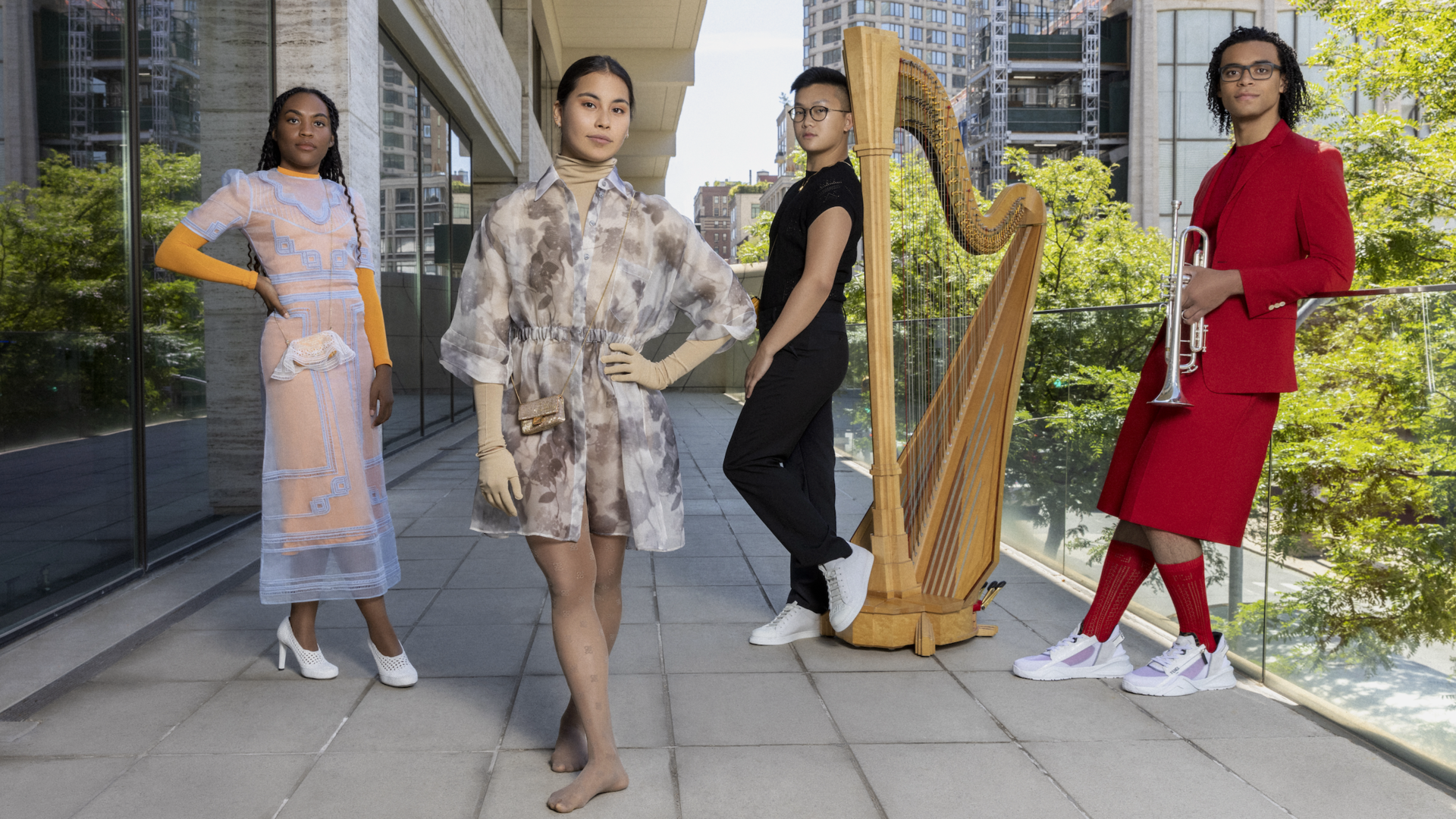 Four students pose outside wearing Fendi attire
