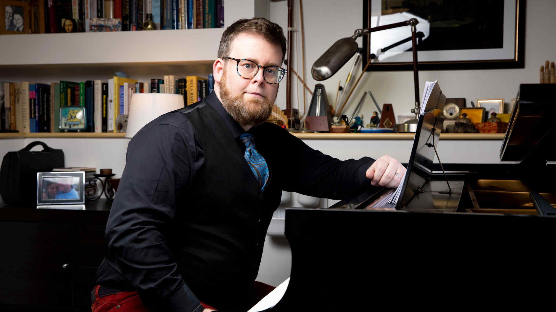 David Ludwig seated at piano in a posed professional headshot