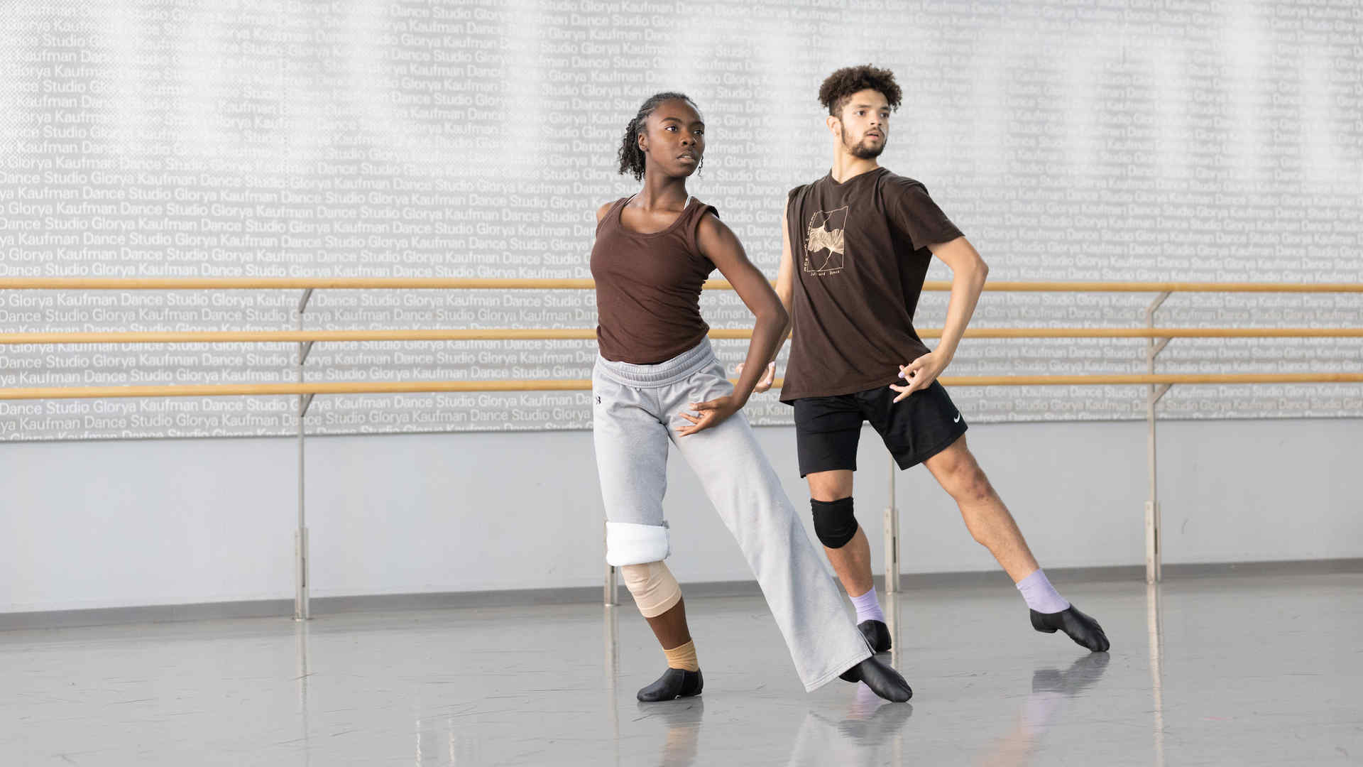 Two dancers in a rehearsal studio practicing