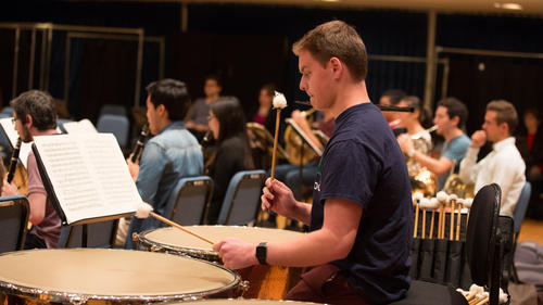 Percussion player in an orchestra rehearsal