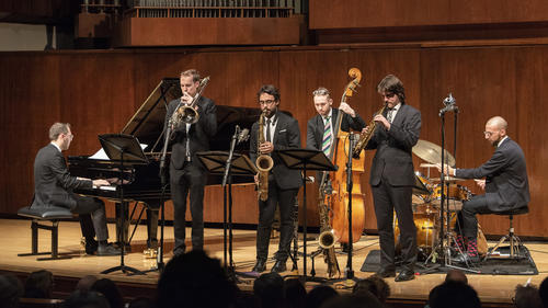 The Juilliard Jazz Artist Diploma Ensemble (The Duke Ellington Ensemble) performs. The ensemble includes:  Lluc Casares, tenor saxophone and clarinet; Gideon Tazelaar, tenor and soprano saxophone; Kasperi Sarikoski, trombone; Addison Frei, piano; Mark Lewandowski, bass; Francesco Ciniglio, drums.