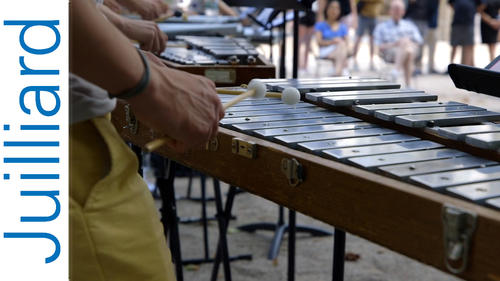 hands of a student playing a xylophone
