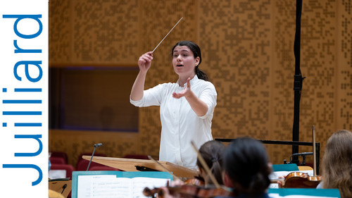 Woman conducting an orchestra rehersal