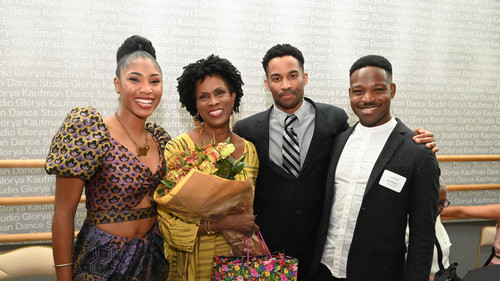 group of four people posing for a photo