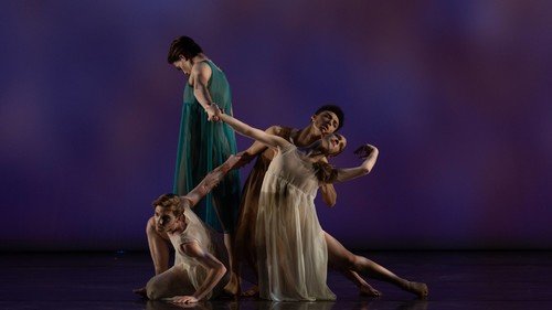 small group of dancers performing on a stage