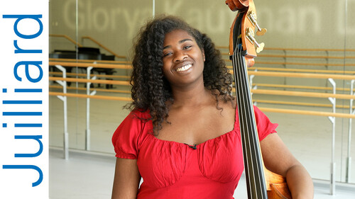 student standing with a stringed instrument
