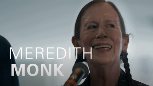 woman sings while looking at camera