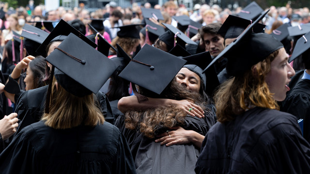 graduates hugging during commencement