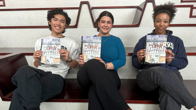 Three students sitting on the large steps at Juilliard's front entrance each hold a copy of 'The New Yorker' magazine. The magazine cover features an illustration of a dance studio with large windows, showcasing people engaged in music and dance. The students smile and they all seem proud to be displaying the magazine.
