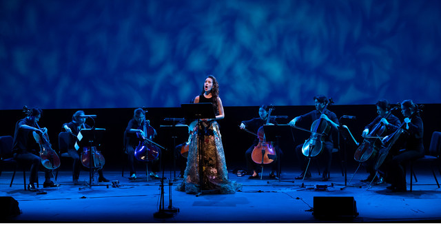 Vocalist performing in front of an orchestra